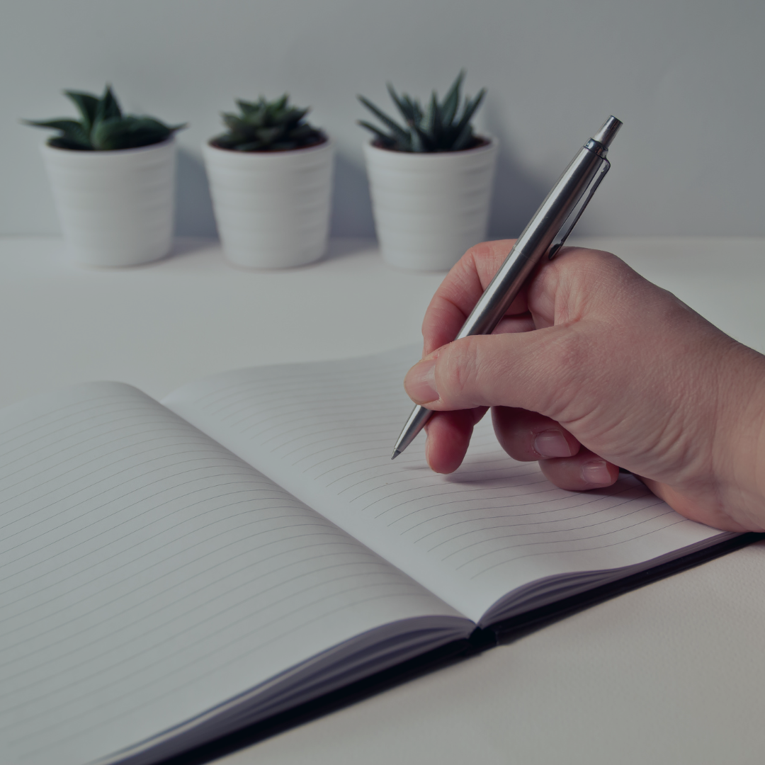 Person writing in book